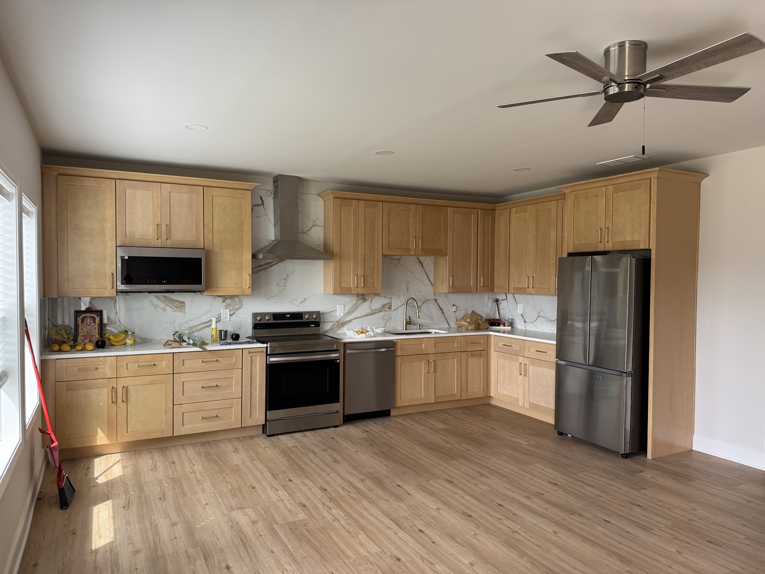 Wood-look tile floor in a kitchen with natural wood cabinets